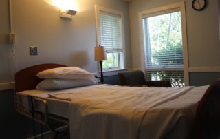 Casey House patient bed and visitors chair